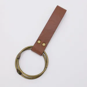 Detail view of medieval PU leather strap with antique brass rings, cosplay prop accessory.