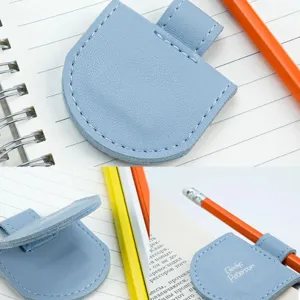 Detail view of light blue PU leather magnetic bookmark and pencil holder clip for notebooks.
