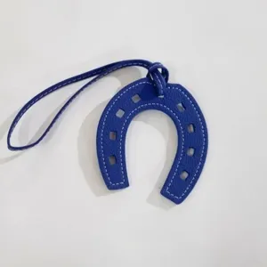 Blue leather horseshoe bag charm with white stitching, stylish PU leather pendant for handbag.