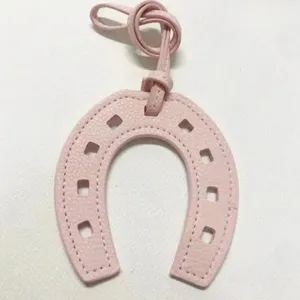 Pink horseshoe leather bag charm pendant, stylish PU leather U-shaped accessory for handbags.