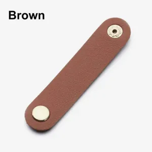 Close-up detail of the brown PU leather cord organizer strap with metal snap buttons.