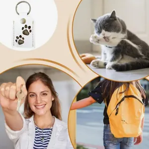 Close-up detail of pet hair storage PU leather keychain with cute paw print design.