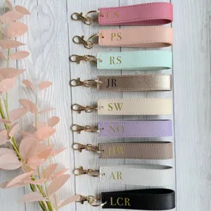 Detailed shot of customized PU leather keychains with metal clasps in multi-color options.