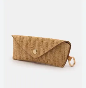 Woven straw glasses storage pouch detail shot, natural texture, portable and compact design.