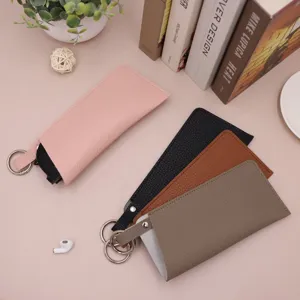 Close-up detail view of portable PU leather glasses pouch with spring ring in multiple colors.