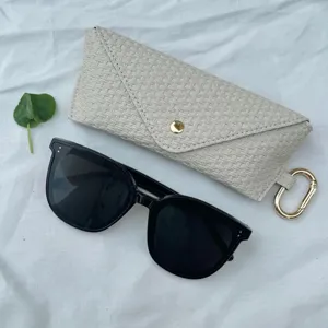 Woven sunglasses case and black oversized sunglasses set, portable travel storage bag.