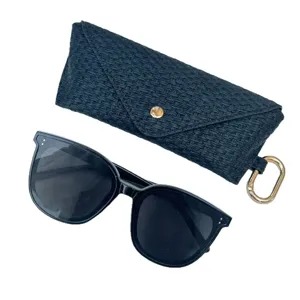 Black sunglasses and woven texture portable glasses case set with metal ring clasp.