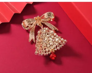Detailed view of a gorgeous Christmas bow pearl bell brooch pin, exquisite metallic texture.