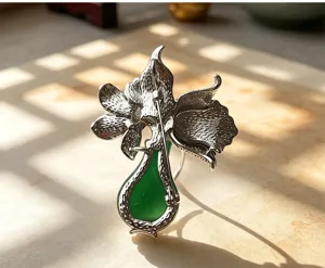 Detailed view of a sophisticated tulip flower vase brooch in silver tone with green stone accent.