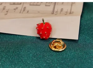 Close-up of the cute red strawberry brooch with gold-plated pin back, detailed enamel design.