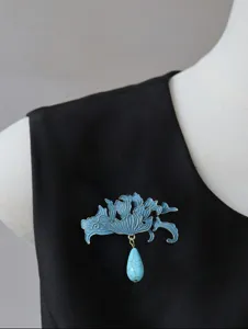 Exquisite Chinese style enamel brooch detail, elegant wave petal design with turquoise pendant.