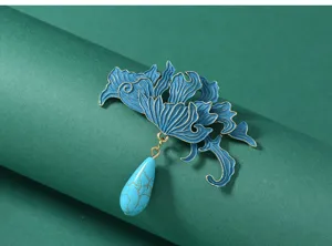 Exquisite detail shot of the vintage Chinese style blue enamel brooch with gemstone pendant.