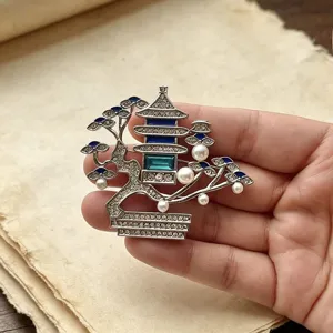 Close-up detail of the Chinese style pavilion pearl brooch, showing exquisite rhinestone and enamel.