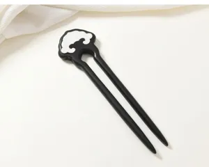 Detailed view of the traditional Chinese style wood hair stick with ruyi motif decoration.