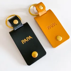 Leather keychain with metal ring and snap button, custom embossed dad gift accessory for men.