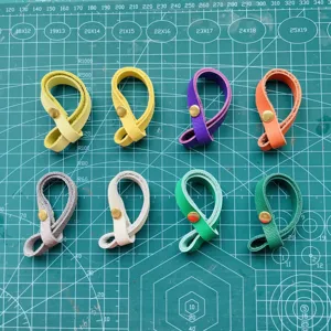Colorful PU leather bag strap connectors with metal snap buttons, multi-color accessory detail.