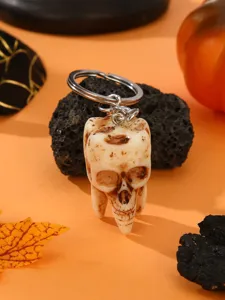 Halloween spooky skull tooth keychain pendant, unique gothic resin bag charm accessory.