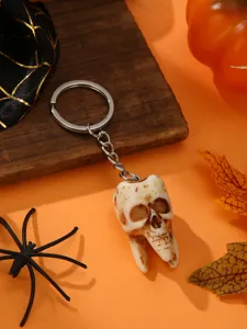 Detailed view of creative Halloween skull tooth keychain pendant for spooky festival decor.