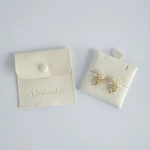 Beige velvet jewelry pouch with snap button and matching display card for ring storage