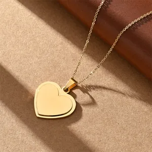 Close-up detail of a minimalist double heart gold pendant necklace, stainless steel jewelry.