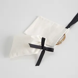 Baumwoll Beutel mit schwarzer Schleife für Schmuck, Detailansicht der Aufbewahrungstasche.