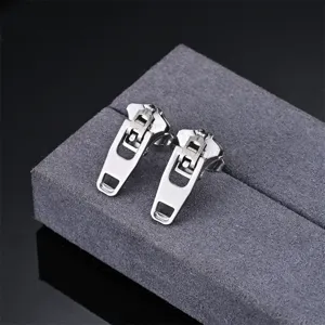 Stainless steel zipper shape earring detail close-up, minimalist silver metal design showcase.