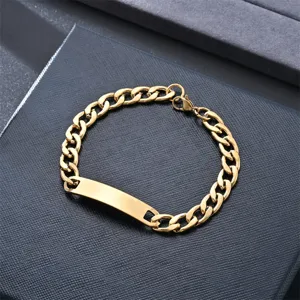 Gold stainless steel Cuban link ID bracelet detail close-up shot showcasing smooth polished metal finish.