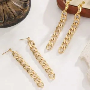 Detailed close-up view of stylish gold chunky chain fringe earrings, fashion metal jewelry.