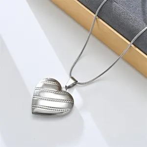 Stainless steel heart locket pendant necklace, retro French openable design detail shot.