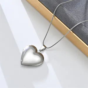 Stainless steel heart locket pendant necklace close-up view detailed shot silver collarbone chain