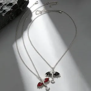 Detailed view of gothic dragon pendant necklace set, featuring red and black alloy dragon charms.