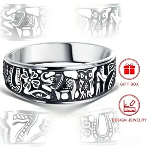 Close-up detail of the retro blackened carved ring featuring elephant and owl motifs.
