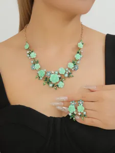 Mint green camellia flower necklace and earrings set with rhinestones and pearls.