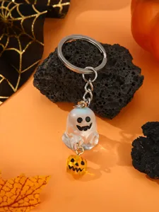 Close-up details of Halloween luminous ghost keychain charm with mini pumpkin pendant accessory.