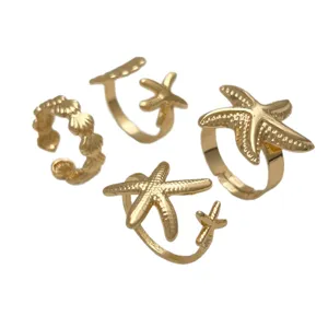 Conjunto de 4 anillos abiertos dorados de estrella de mar y concha playa vacaciones ajustable