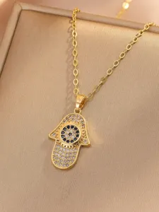 Close-up detail of the gold-plated Hamsa hand pendant necklace with sparkling zirconia stones.