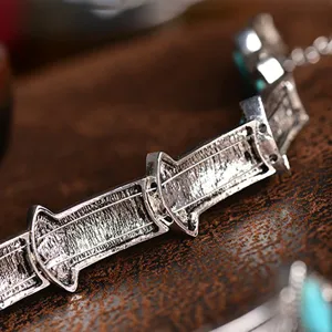 Close-up detail of vintage bohemian alloy turquoise necklace links, stylish retro design.