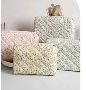 Detailed view of quilted floral cosmetic pouch featuring soft fabric and neat zip closure.