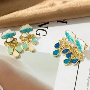 Detailed close-up of cute cloud and teardrop tassel earrings with enamel drip oil finish.