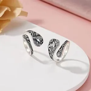 Detailed close-up shot of the vintage silver adjustable ring showcasing exquisite hummingbird and sunflower carvings.