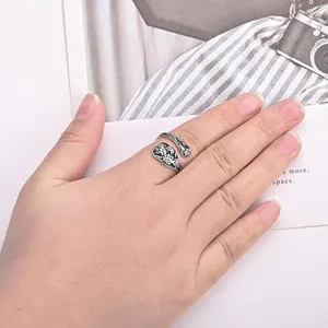 Vintage silver carved floral spoon ring detail shot showing intricate retro design and texture.