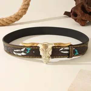 Vintage Western style cowhide leather belt with steer skull buckle and carved feather detail.