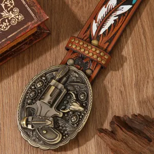 Vintage western leather belt with carved feather pattern and revolver metal buckle detail.