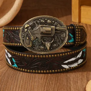 Close-up detail of the vintage western leather belt with carved floral and revolver buckle.