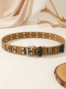 Close-up view of a vintage brown canvas belt featuring gothic letter print and metal eyelets.