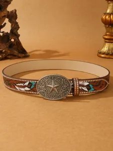 Detailed view of western style embossed leather belt with vintage metal buckle and feather motif.