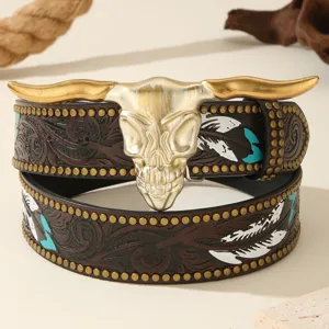 Detailed view of American western style leather belt with carved floral and feather motifs.