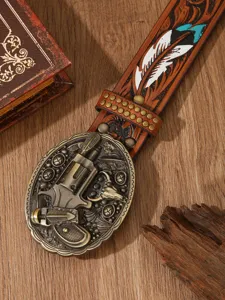 Detailed view of the western style vintage leather belt with gun buckle and carved feather.