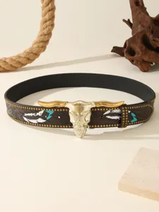 Detail shot of Western style embossed leather belt with bull skull buckle and metal studs.