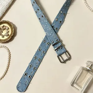 Punk style blue denim belt featuring double row metal eyelets and stylish decorative buckles.